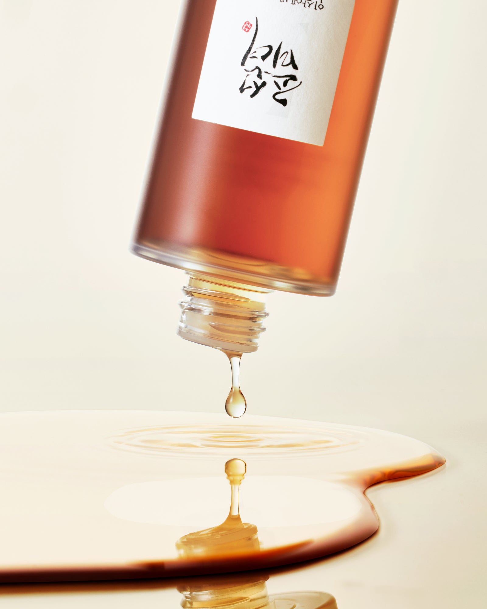 a bottle of liquid dripping from a drop of liquid