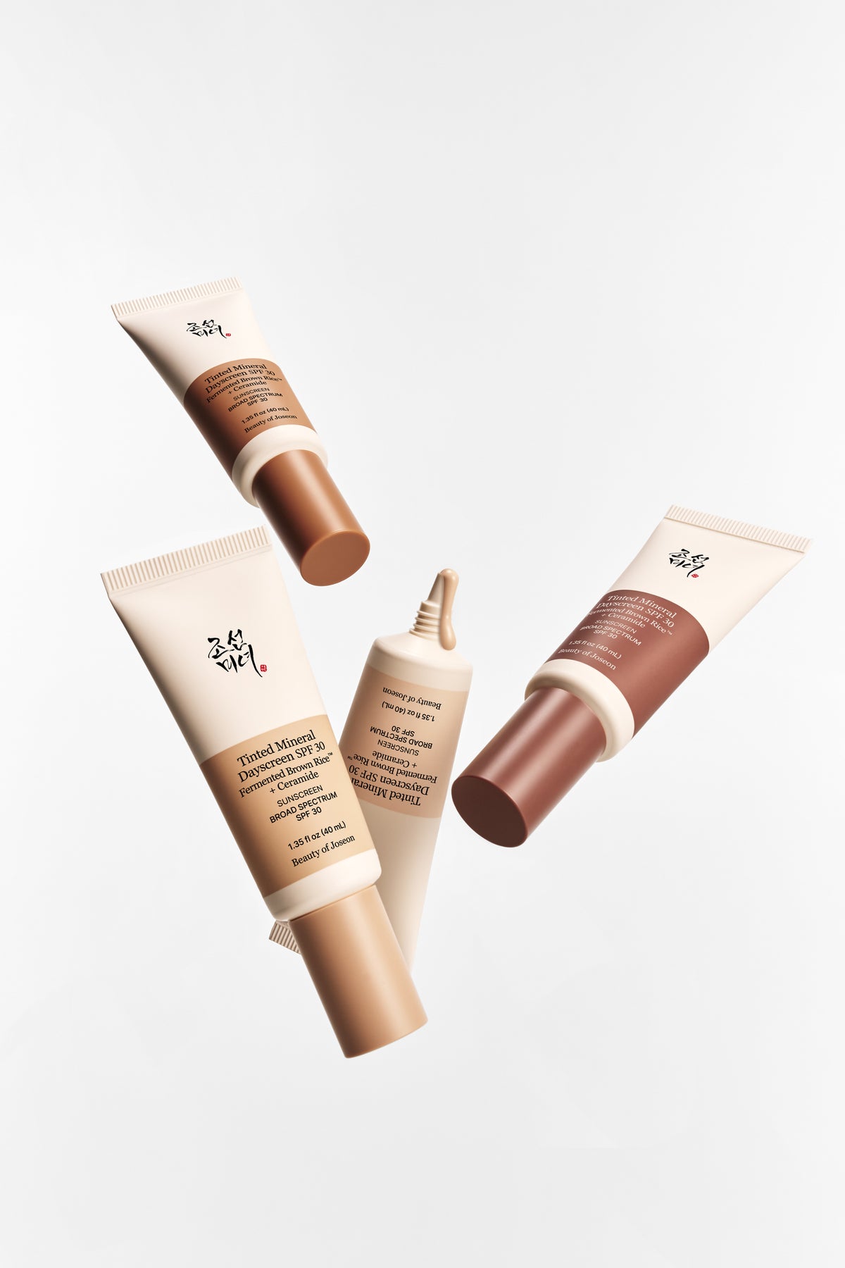 Four Beauty of Joseon Tinted Mineral Day Screen products are placed against a gray-toned background.