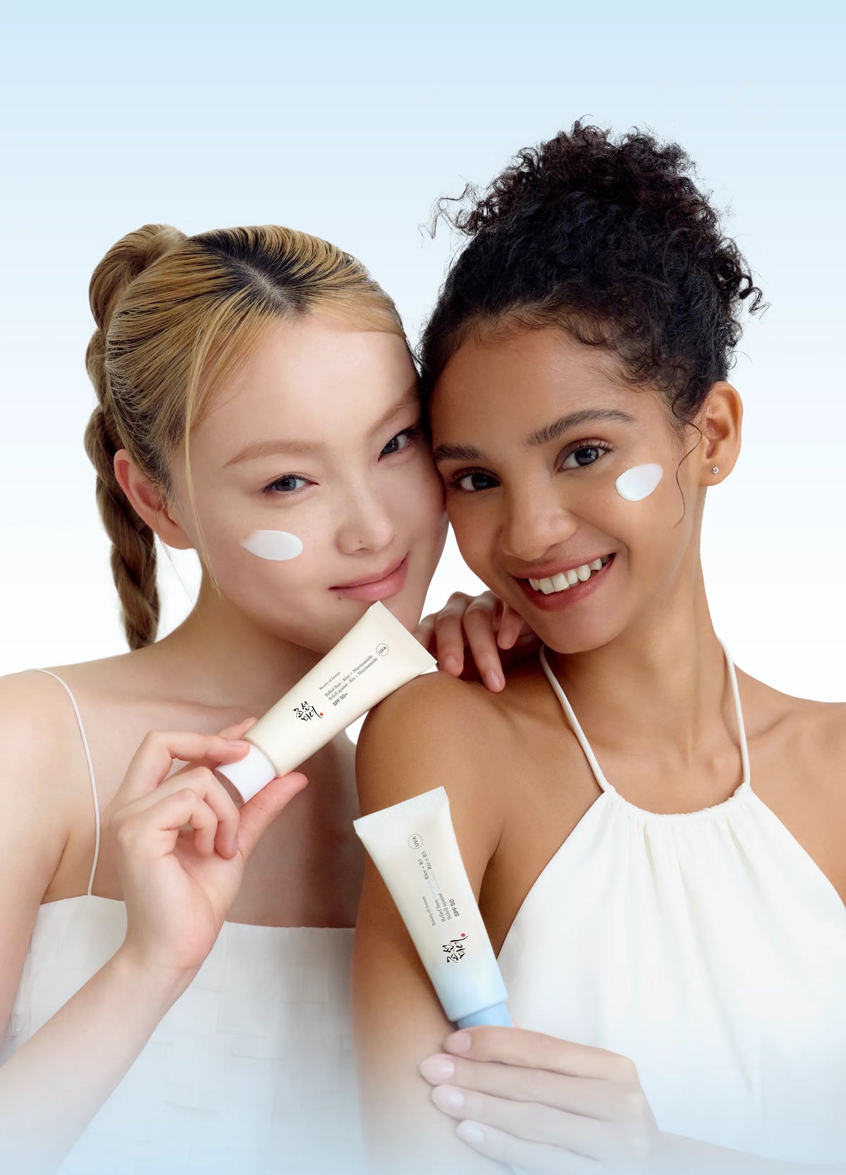 two women holding up creams