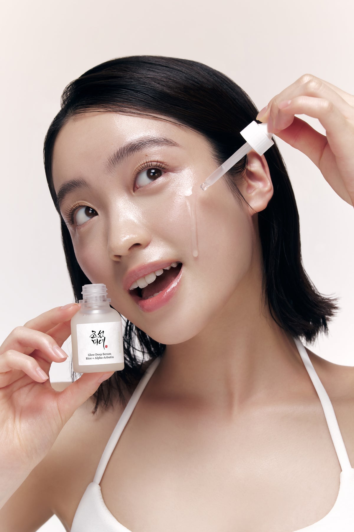 a woman with a dropper on her face